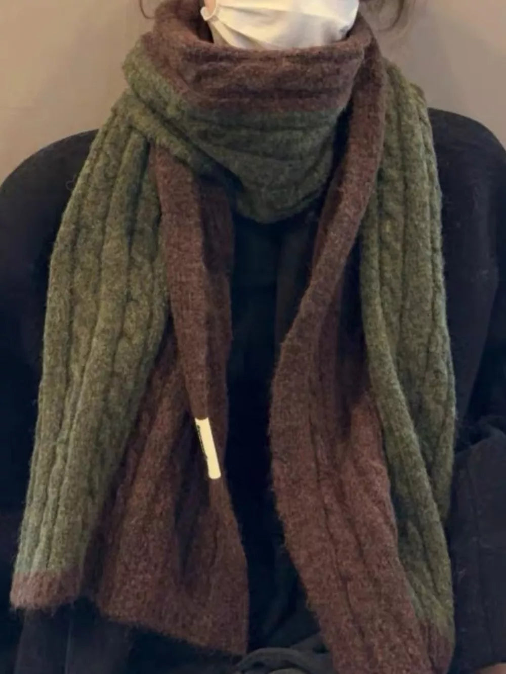 Textured two-tone wool blend scarf in brown and green with cable knit detail.