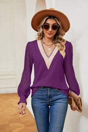Purple V-neck blouse with lace sleeves and textured trim