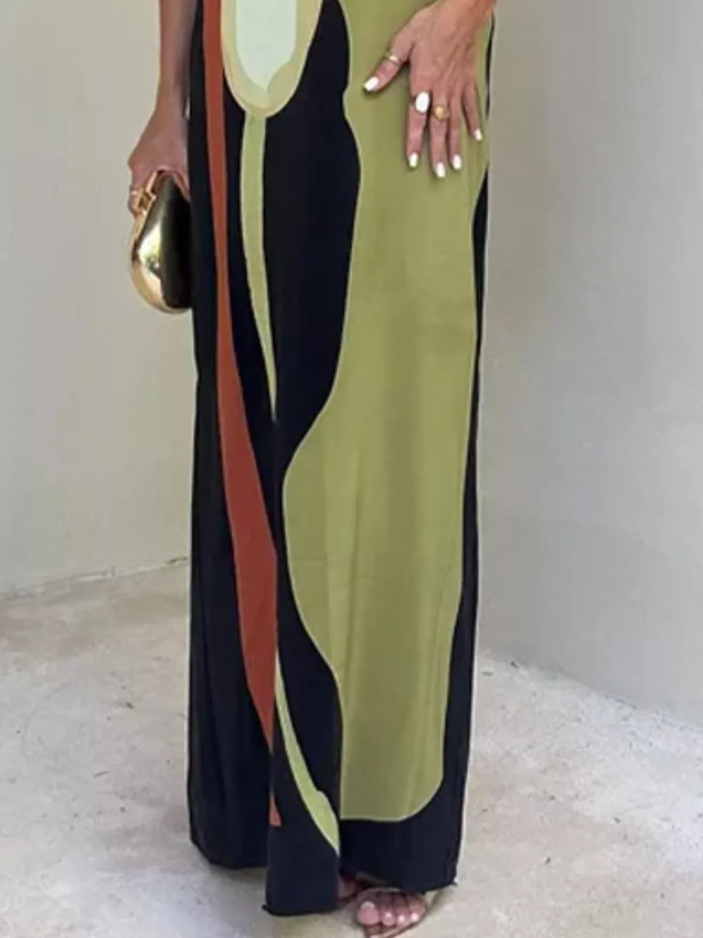 Strapless maxi dress with abstract print in black, green, and rust.