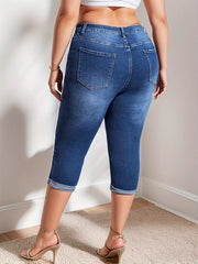 Dark blue denim capri jeans with cuffed hems and a high waist.