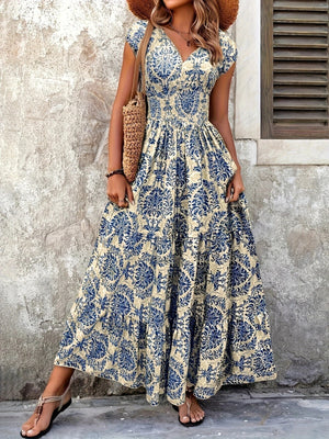 Blue flower damask print cap sleeve maxi dress with smocked waist and tiered skirt.