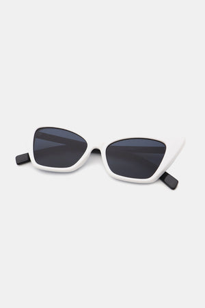 White acetate cat-eye sunglasses with sharp angular frames and black lenses.
