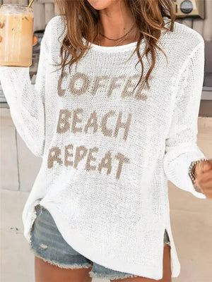 White knit sweater with "Coffee Beach Repeat" graphic and side slits