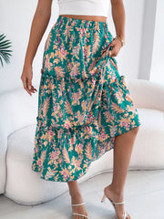 Green floral midi skirt with ruffle hem and tiered design.