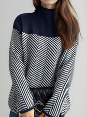 Chevron knit turtleneck sweater with colorblock pattern in dark blue and white.