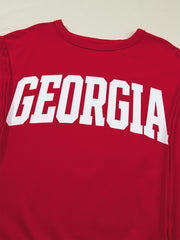 Red cotton blend t-shirt with white "GEORGIA" text graphic and drop shoulders.