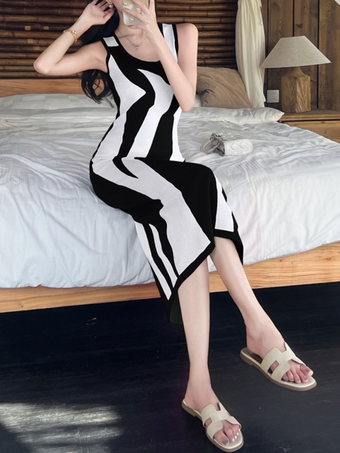 Black and white abstract pattern bodycon midi dress with a scoop neck and sleeveless design.
