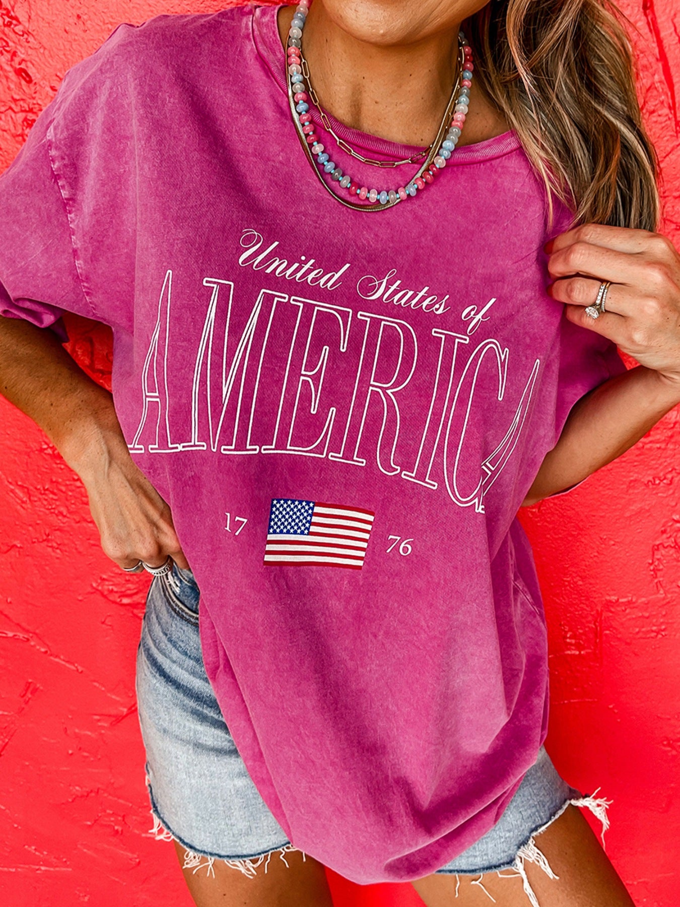 Patriotic graphic cotton t-shirt in pink with United States of America text and American flag detail.