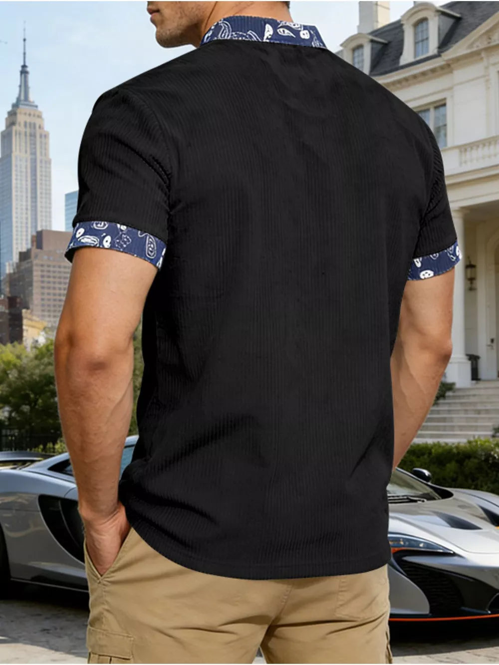 Black men's t-shirt with short sleeves, ribbed texture, and paisley print collar and cuffs.