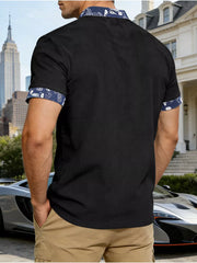 Black men's t-shirt with short sleeves, ribbed texture, and paisley print collar and cuffs.