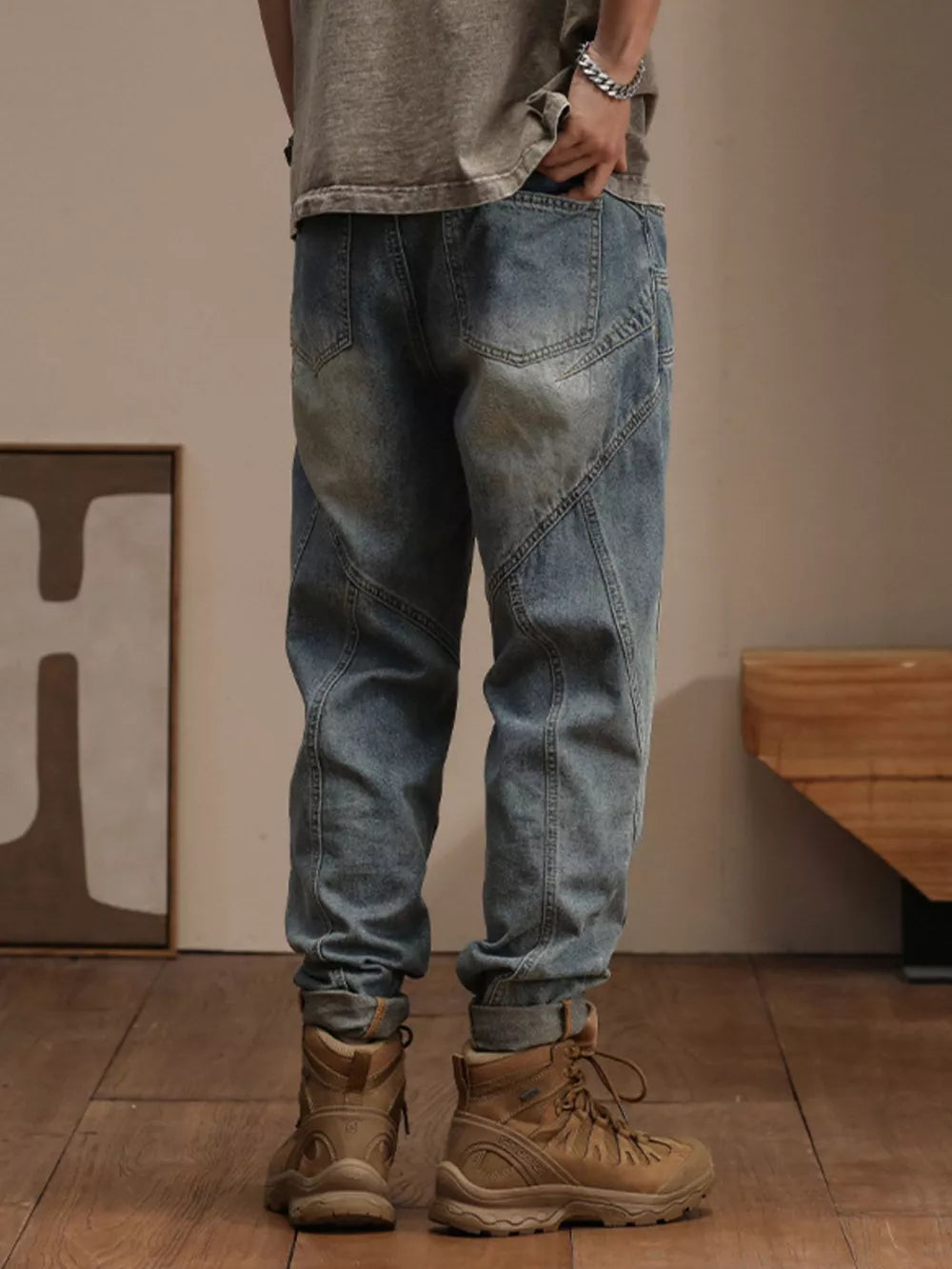 Relaxed fit vintage wash denim jeans with paneling detail, cuffed ankles.