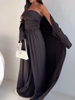 Black three-piece outfit set with ruched strapless top, wide-leg pants, and open-front cardigan.