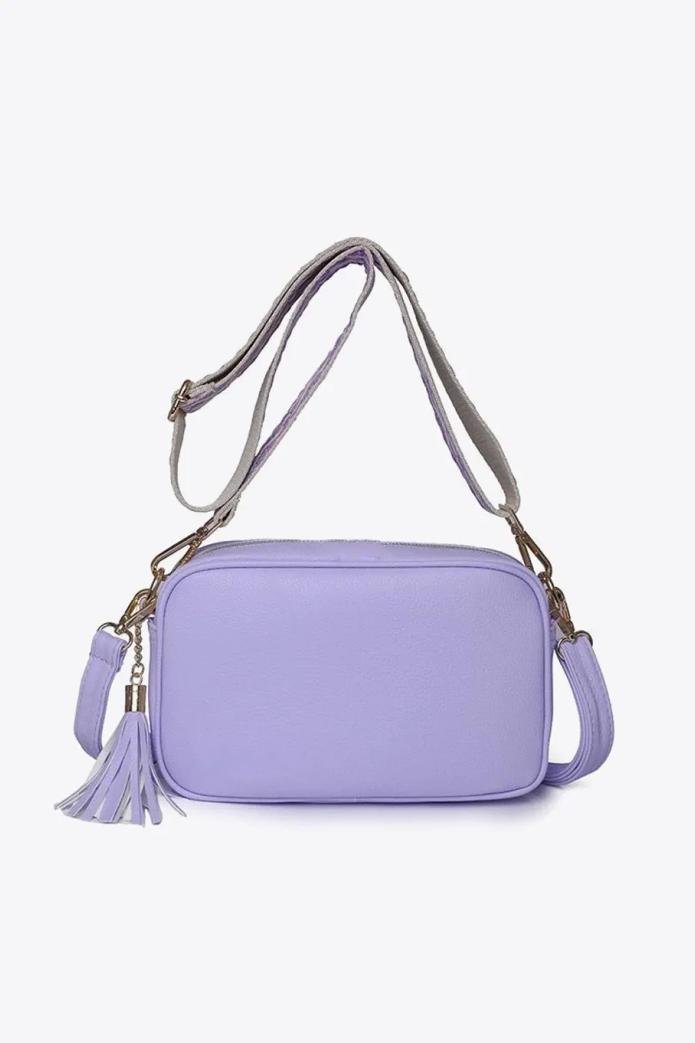 Lavender textured crossbody bag with tassel detail and adjustable strap