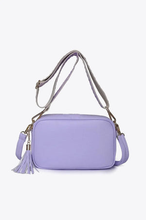 Lavender textured crossbody bag with tassel detail and adjustable strap