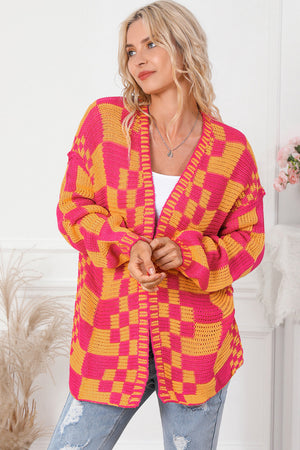 Checkerboard knit open cardigan in orange and pink acrylic with a relaxed fit.