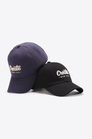 Navy and black baseball caps with white "Create New Life" embroidery.