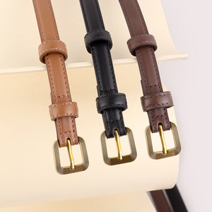 Sleek cowhide leather accent belts in brown, black, and caramel with antique brass buckles.