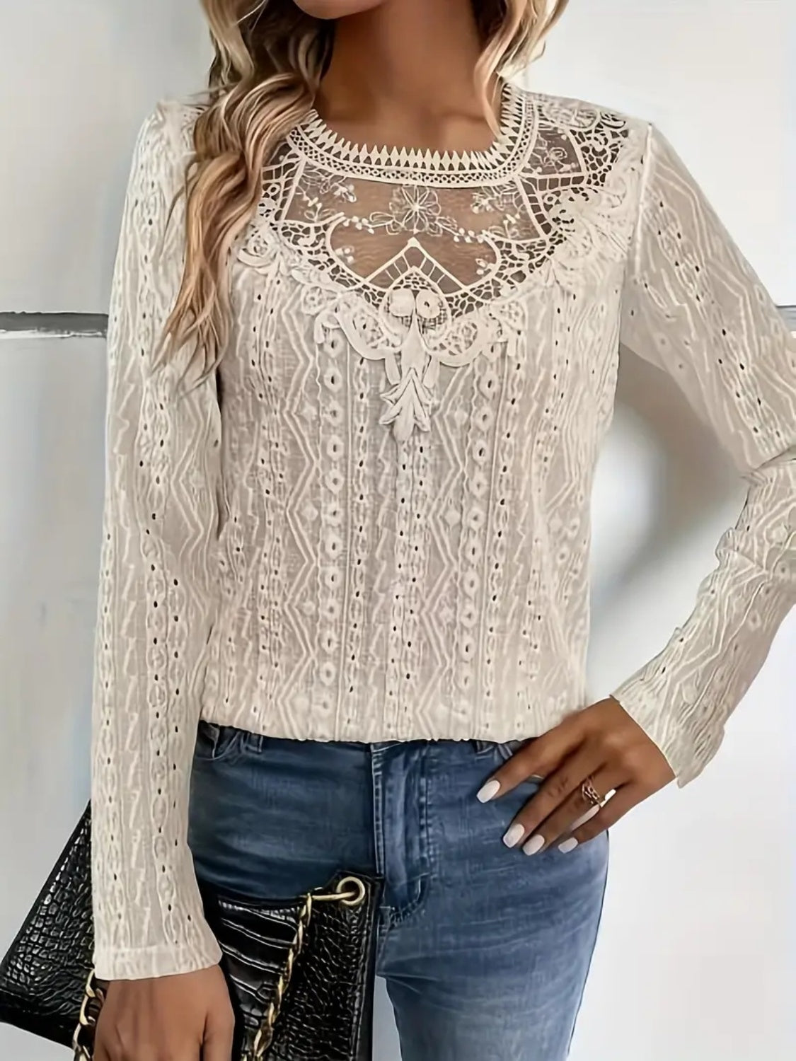White eyelet embroidered blouse with lace yoke and long sleeves.