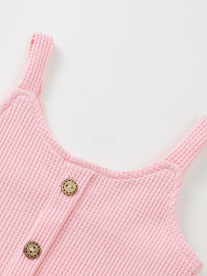 Pink waffle knit tank top with wooden buttons, part of a baby outfit set.