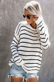 Relaxed white and black striped knit pullover sweater with crew neck.