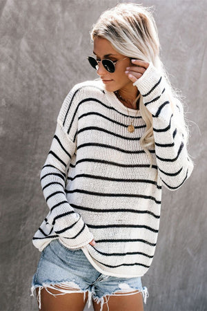 Relaxed white and black striped knit pullover sweater with crew neck.