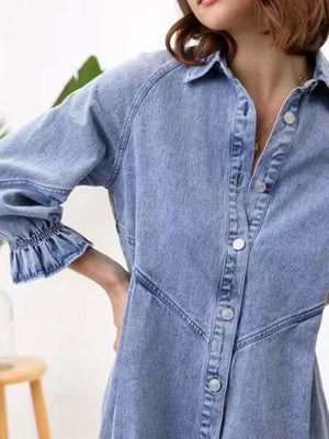 Denim button-down dress in dusty blue with ruffled cuffs and silver buttons.