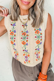 Beige cable knit vest with colorful floral embroidery and a crew neck.