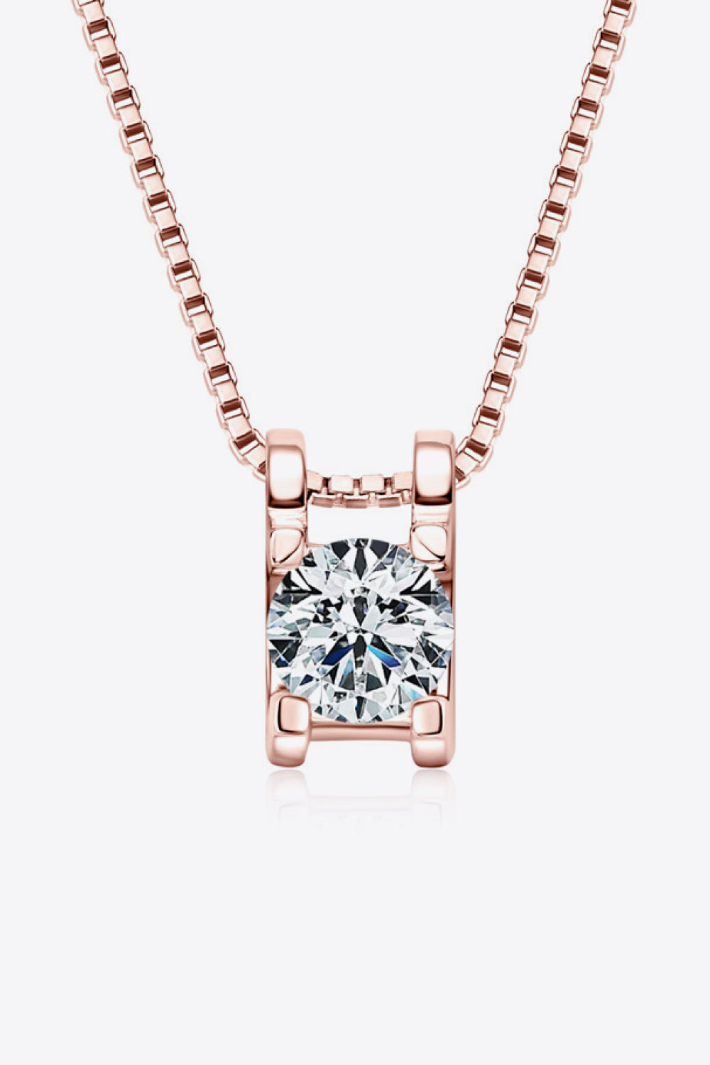 Rose gold necklace with a cubic zirconia pendant in a rectangular setting.