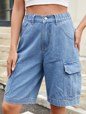 Medium wash denim cargo bermuda shorts with elastic waist and utility pockets.
