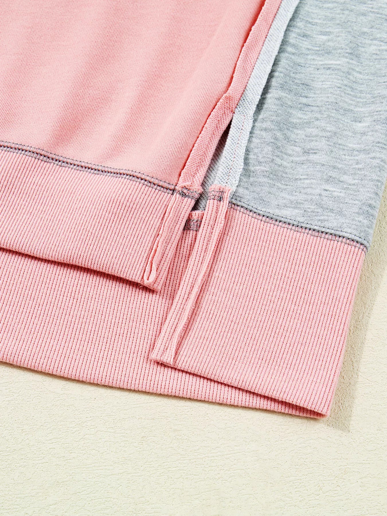 Oversized Dusty Pink sweatshirt with contrast stitching and side slits.