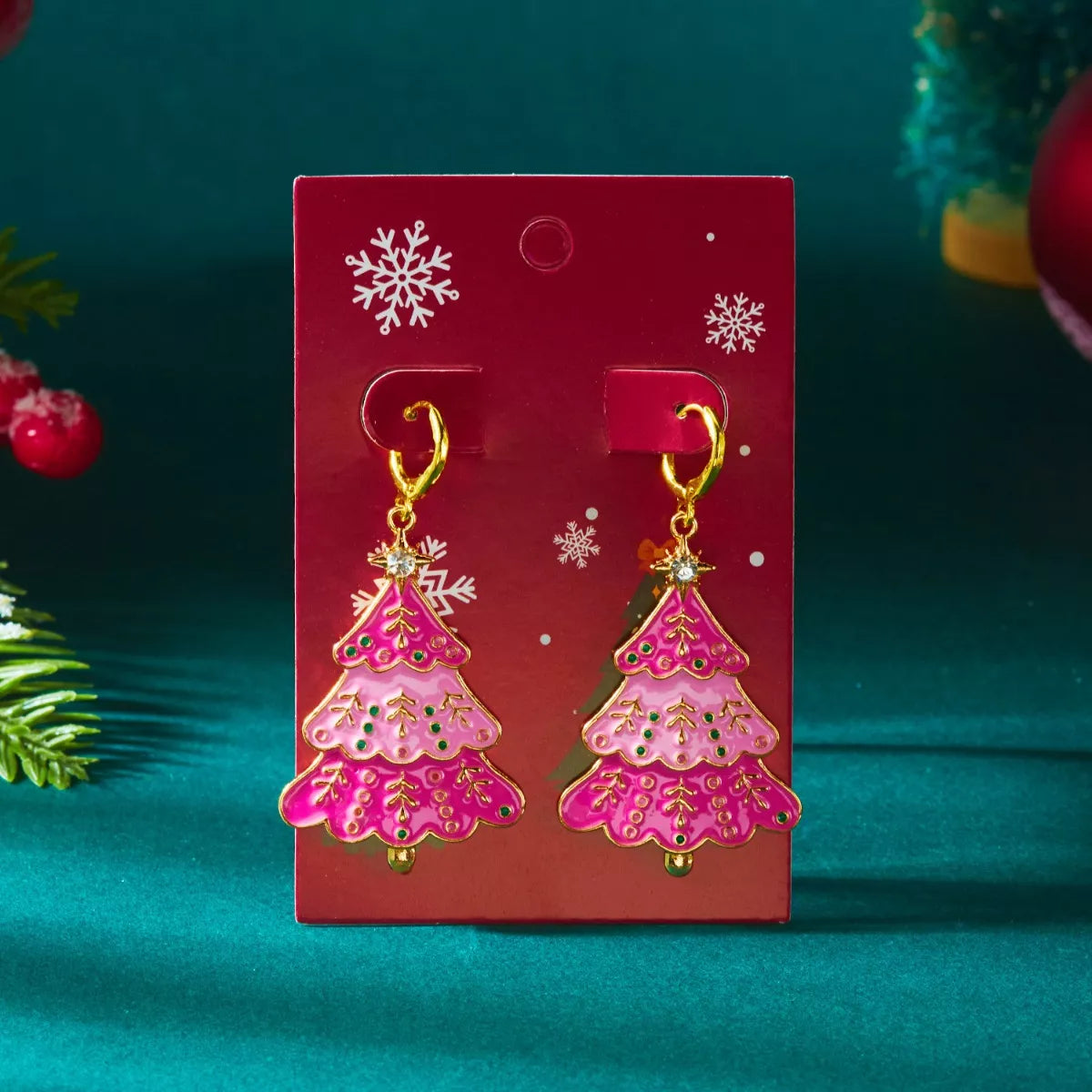 Christmas tree dangle earrings in blush pink with green accents and gold hoops.