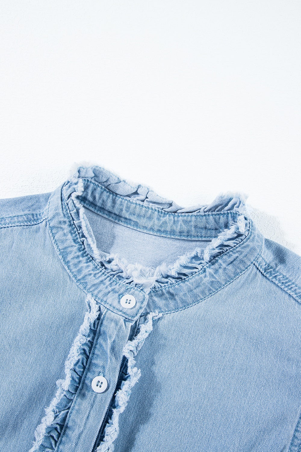 Light blue denim button-up shirt with frayed ruffle trim and a band collar.