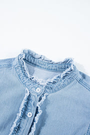 Light blue denim button-up shirt with frayed ruffle trim and a band collar.