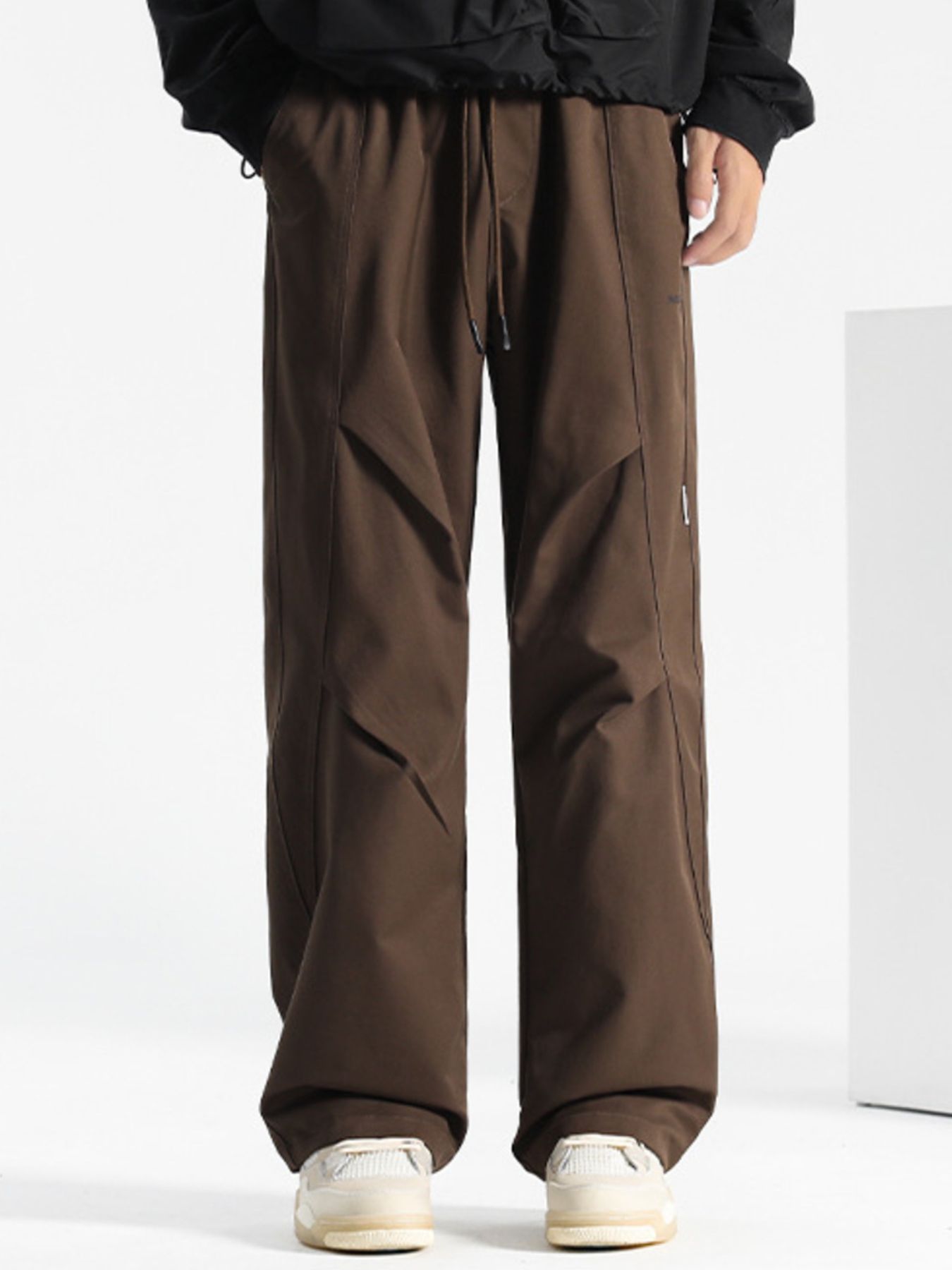 Brown casual drawstring sweatpants with paneled detail and relaxed fit.