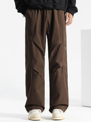 Brown casual drawstring sweatpants with paneled detail and relaxed fit.