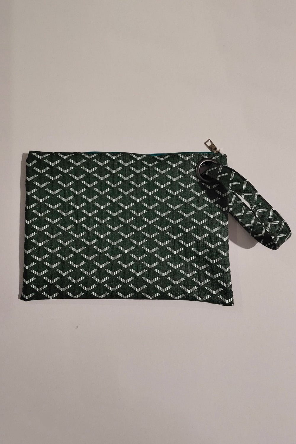 Army green clutch bag with geometric pattern and wrist strap