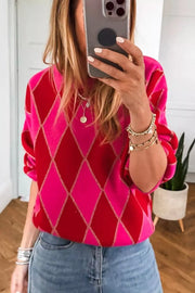 Vibrant argyle knit sweater in deep rose and red with gold sparkle detail and puff sleeves.