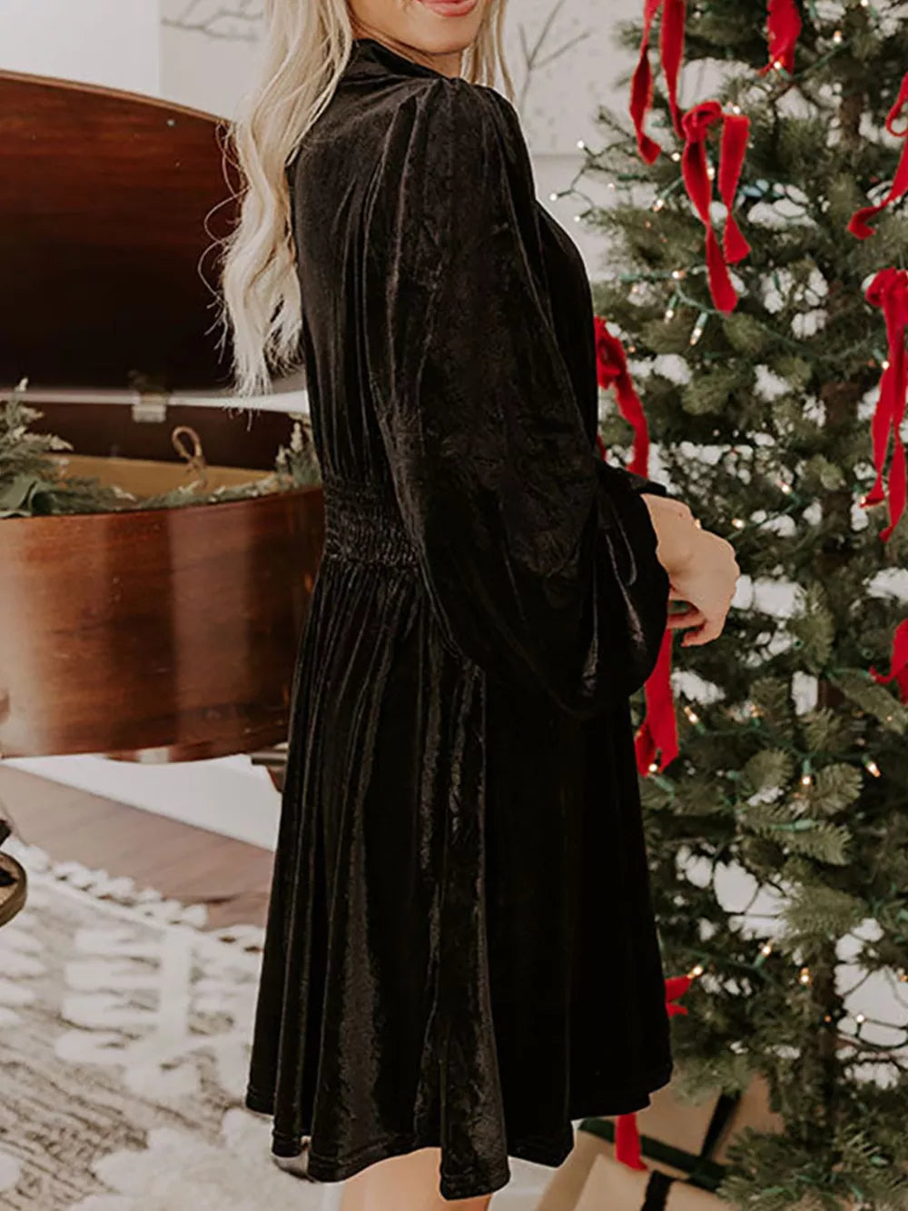 Black velvet mock neck dress with balloon sleeves and smocked waist.