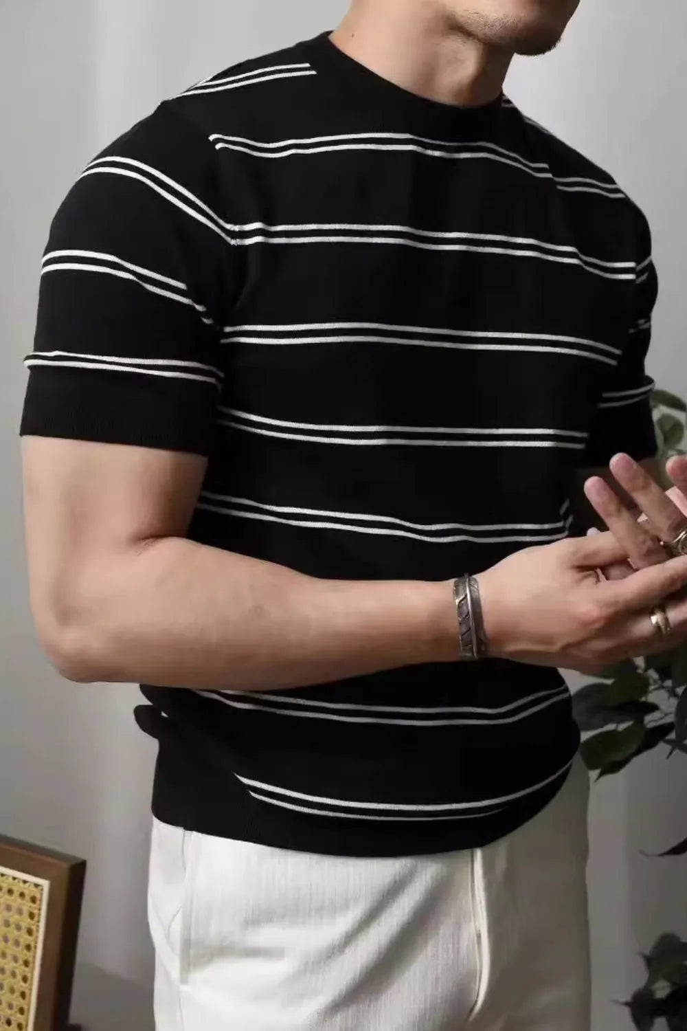 Black ribbed stripe t-shirt with contrast trim and short sleeves.