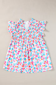 Smocked bodice blouse with brushstroke print, V-neck, and flutter sleeves in a multi-color pastel palette.