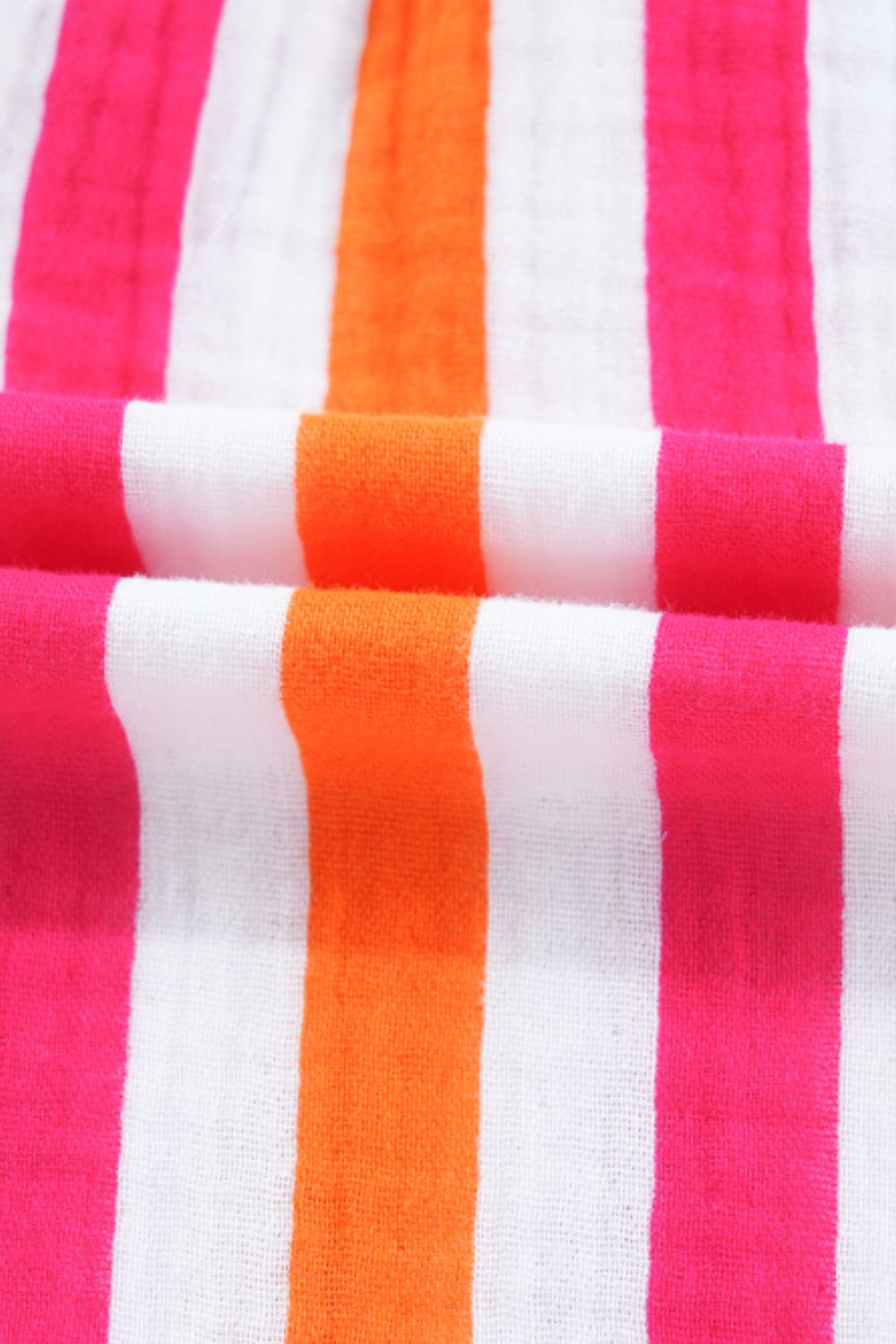 Textured stripe blouse in white with pink and orange vertical stripes.