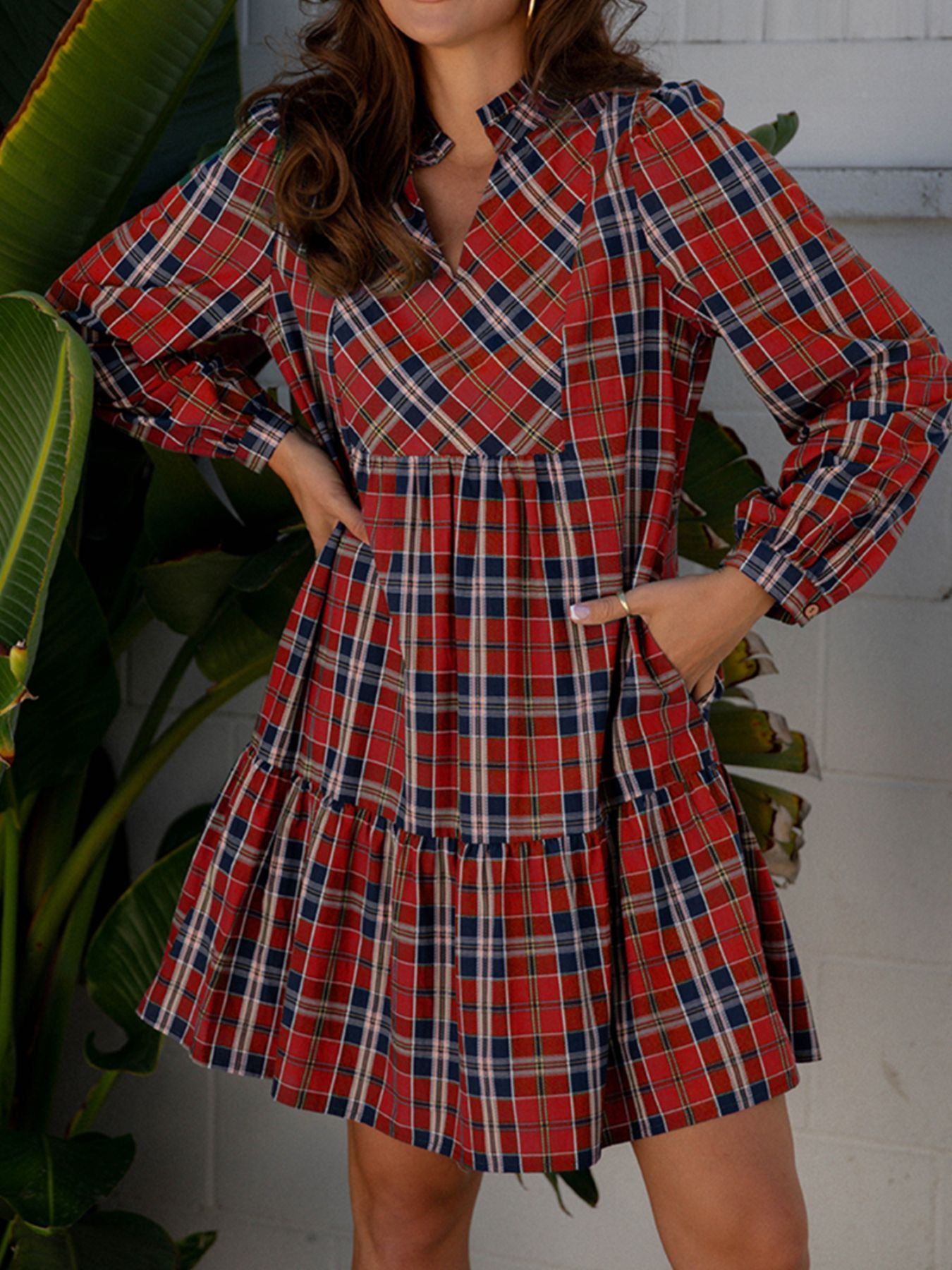 Charming tartan mini dress with frilly collar, V-neck, long sleeves, and tiered skirt.