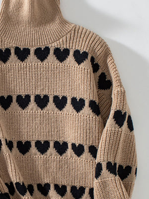 Taupe acrylic turtleneck sweater with black heart intarsia pattern and ribbed details.
