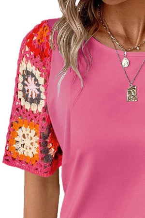 Pink t-shirt with colorful granny square crochet sleeves and crew neck.