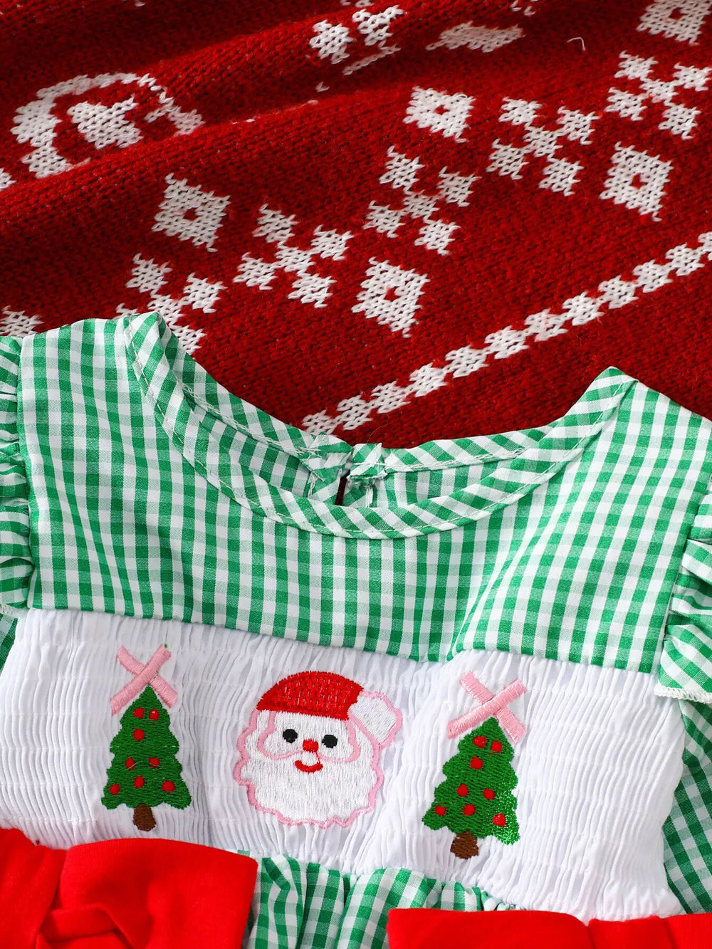Green gingham baby dress with smocked panel featuring Santa and Christmas trees embroidery.
