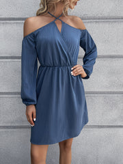 Dusty blue off-shoulder mini dress with cross-strap neckline and long sleeves.