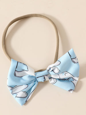 Sky blue baby headband with a bow featuring a whimsical bunny print.