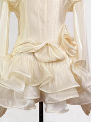 Elegant white ruffled mini dress with corset waist and long sleeves.