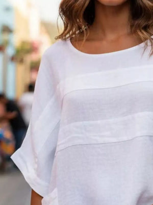 White relaxed fit blouse with horizontal seam details and short sleeves.