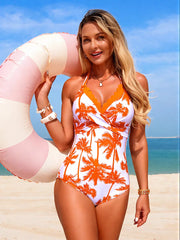 Orange palm tree print halter one-piece swimsuit with scalloped trim and a plunging neckline.